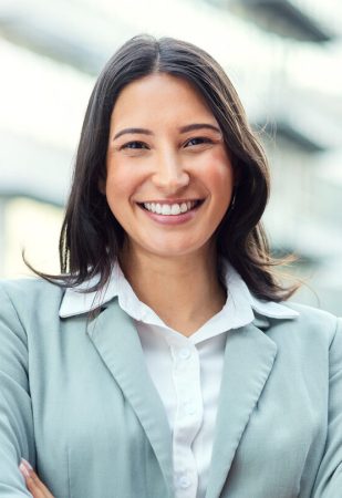 Portrait of a confident young businesswoman standing against an urban background